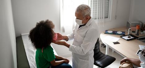 a doctor examining a child